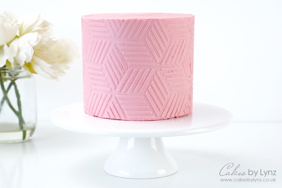 using a textures contour comb on a buttercream cake